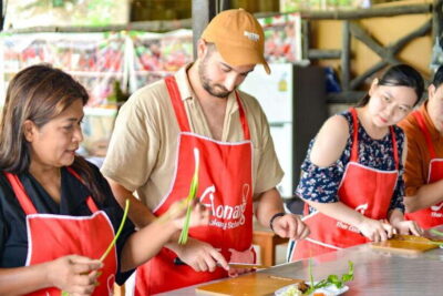 Ao Nang: Half-Day Thai Cooking Class Krabi Province - The kitchen setting: open-air, raised stations, and a temple next door