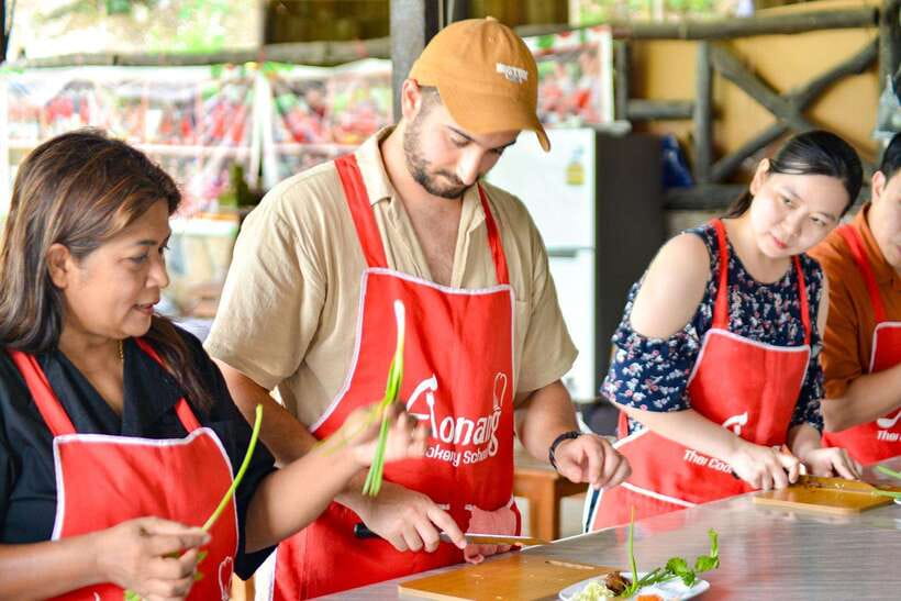 Ao Nang: Half-Day Thai Cooking Class Krabi Province - The kitchen setting: open-air, raised stations, and a temple next door
