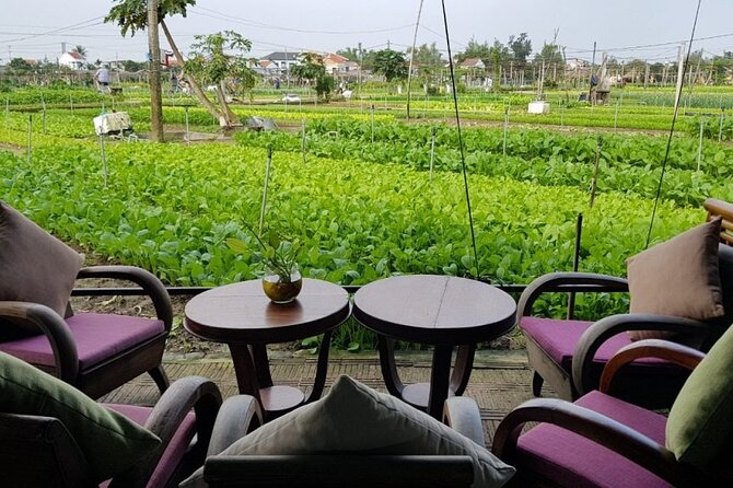 Hoi An Cooking Class With Market Tour and Bamboo Basket Boat Ride - The garden restaurant and cooking school setup