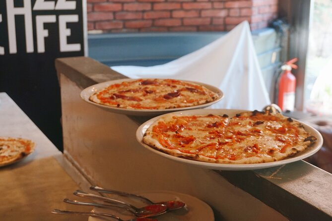 Spritz Making and Pizza Cooking Class in Rome City Center - Watching your pizza bake in a traditional wooden oven