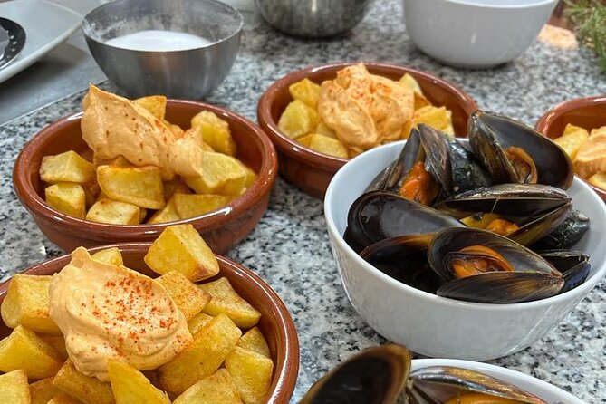 Valencian paella cooking class, tapas and visit to Ruzafa market. - Eating your paella: tomato salad, wines, sweet wine, and cake